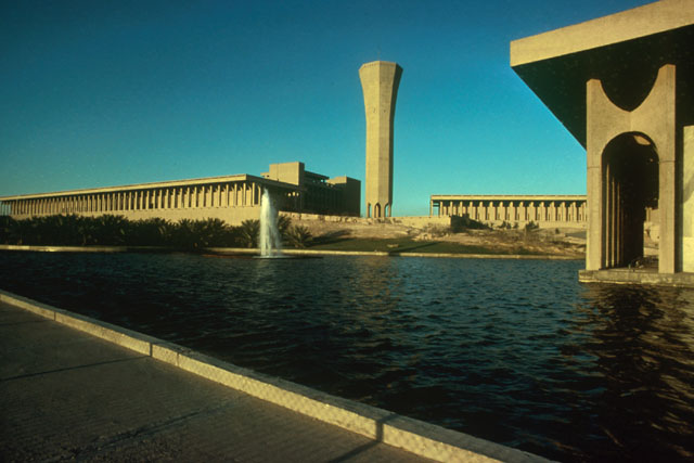 Exterior view showing reflecting pool against façade and water tower