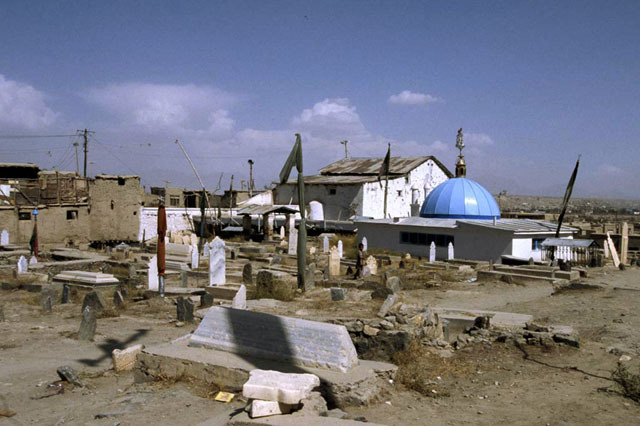 View of the graveyard from west, showing blue-domed tomb of Asheq with community mosque seen behind