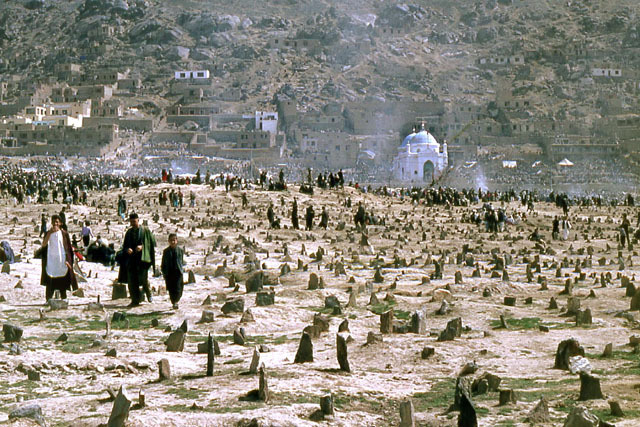 Exterior view, with graveyard in foreground, showing shrine during Nauroz celebrations