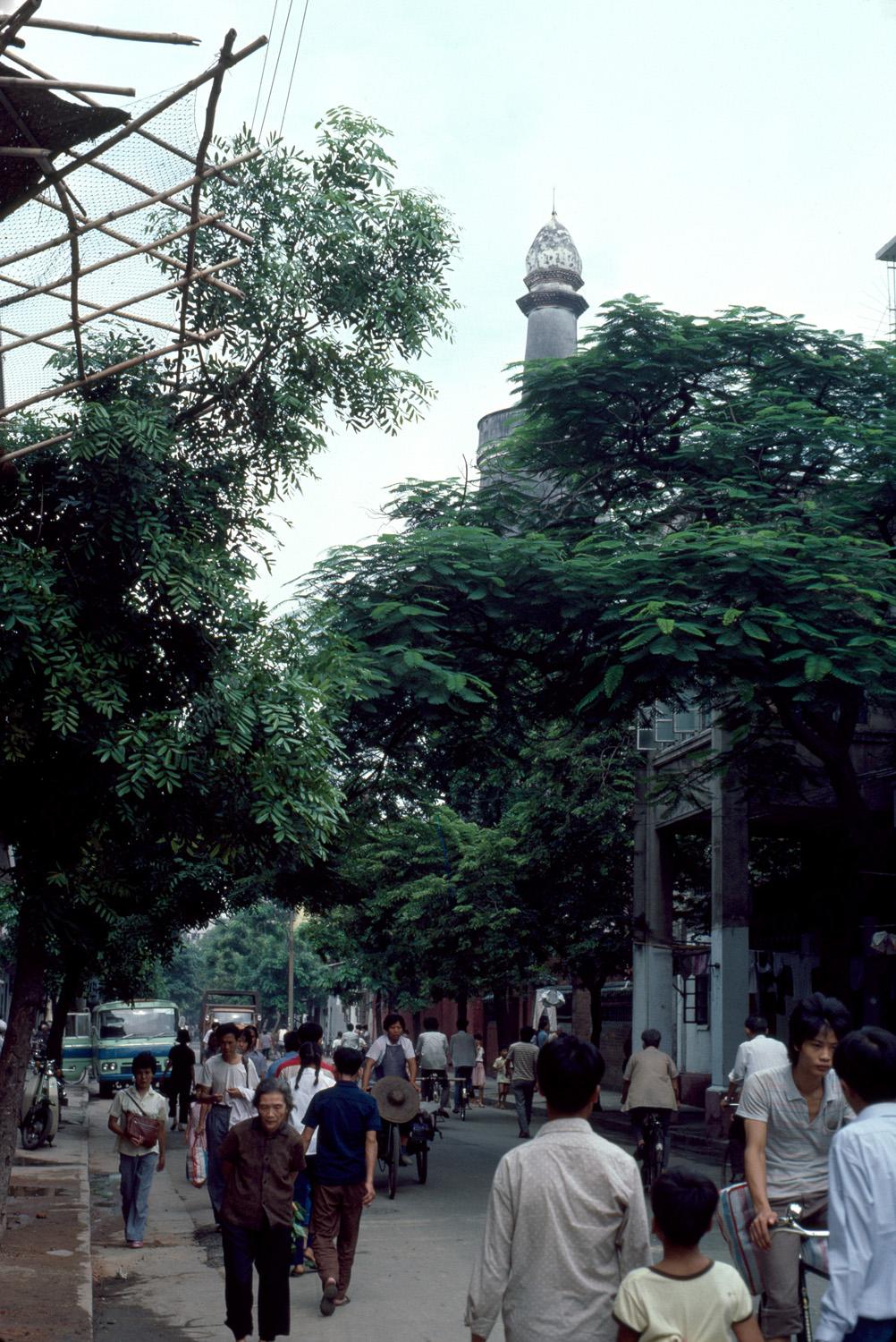 Street façade with light tower rising above the trees
