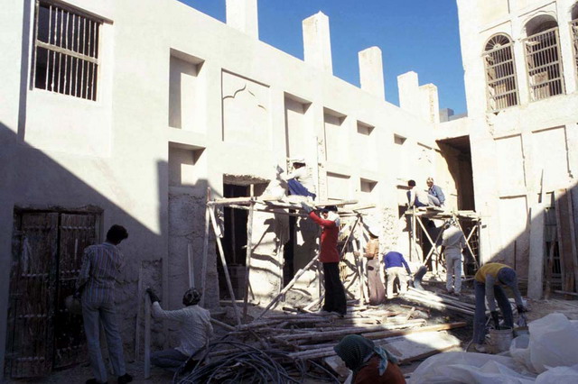 View of courtyard during renovation, plaster work
