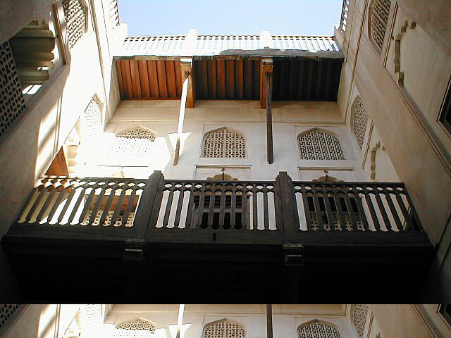 View of southwest courtyard, looking up at wooden balcony and upper floors
