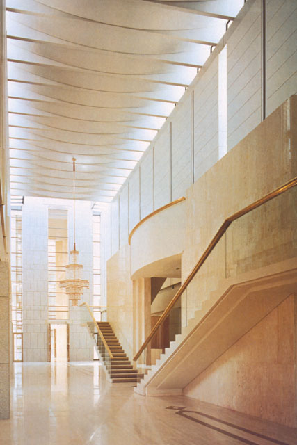 Interior view showing dramatic height of foyer with slats allowing light to enter form ceiling