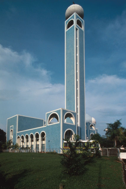 Exterior view showing minaret and double story façade with window cutouts