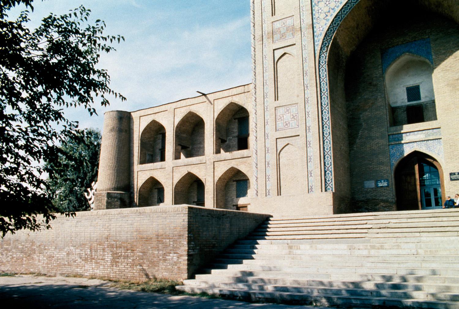 View of entry façade with stairs leading up to the portal