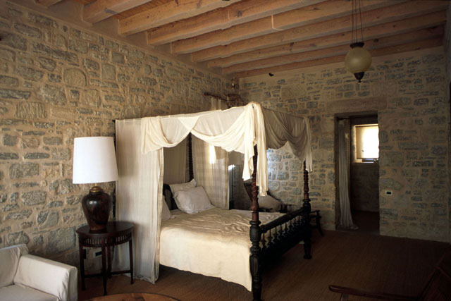 Interior view showing exposed stone walls and timber beam ceilings