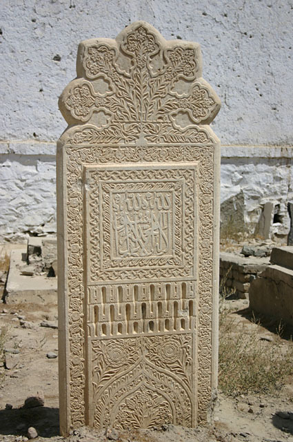 Decorated marble headstone in graveyard, south of community mosque