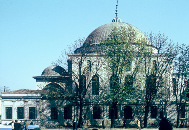 Northwest elevation of mausoleum, with the portico seen to the left of the main domed hall.  Preceding the portico to the left is the 18th hipped roof, century room of the mosque's timekeeper (muvakkithane)