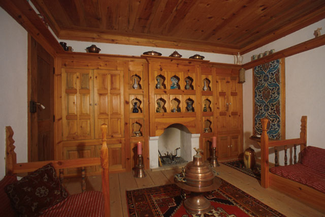Interior view showing elaborate use of wood on ceiling and in built-in cupboards