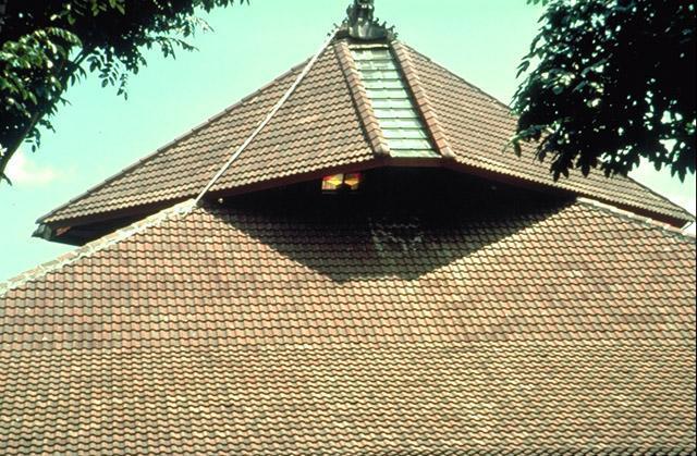 <p>A tiled pitched roof and shifted latern allow light to enter the prayer hall</p>