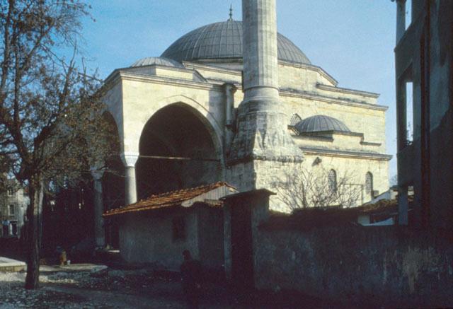 Exterior view from west showing corner of portico, minaret, and convent rooms abutting the domed prayer hall