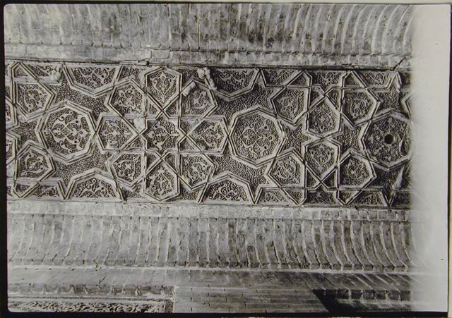 Carved terracotta on ceiling of north-south hall crossing entry axis on west side, before restoration