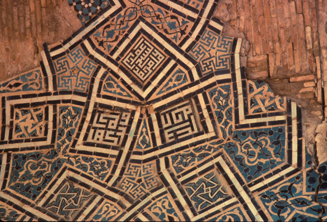 Detail of glazed and painted ceramic on plaster on the central iwan