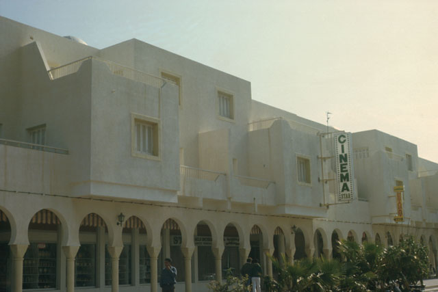 Exterior view showing façade with arcade of shops at lower level
