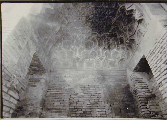 Recess facing west entrance, View with carved terracotta muqarnas vaulting and bricked-up niche, before restoration