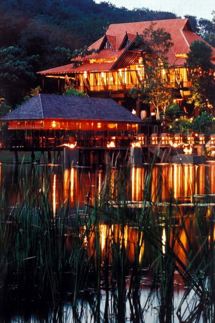 View of dining pavilion from pond, at dusk