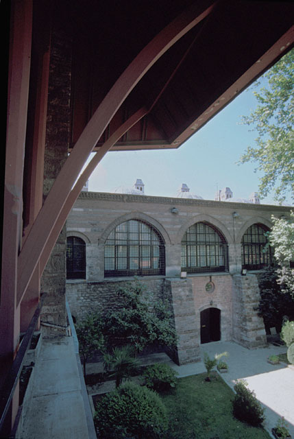 View of second courtyard, looking at northwest wing past the wooden roof of the great hall (divanhane)