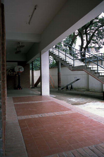 Ground floor colonnade with stairs leading up to the school