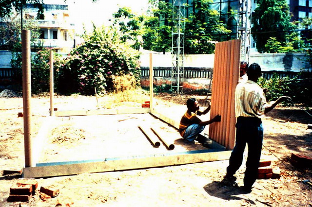 Erection of paper tube walls in galvanized iron channels