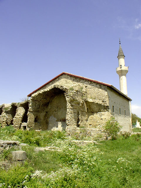 Exterior view from southeast showing ruined madrasa adjoining the mosque's qibla wall