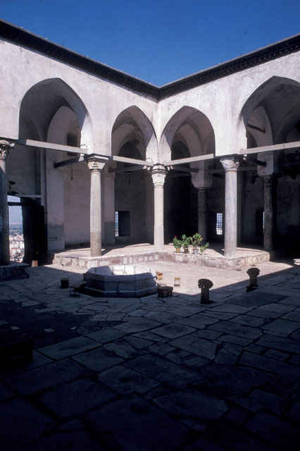 View of courtyard from southwest showing the arcades, fountain and courtyard portal