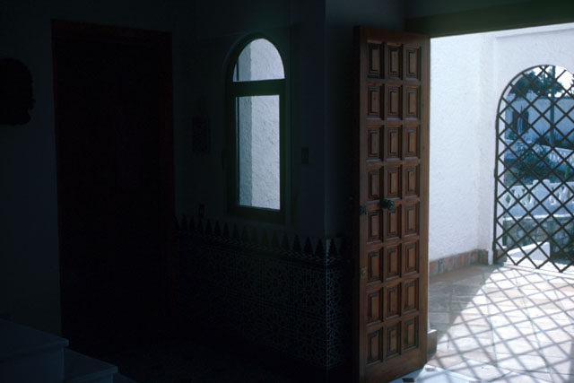 Interior detail showing wood doors and iron lattice work