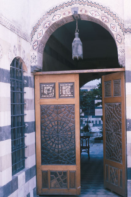 Exterior detail showing carved wooden door