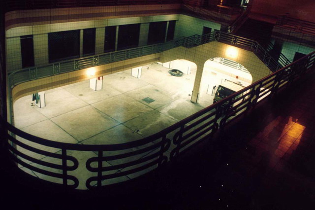 Courtyard at the back of the building with shops along gallery, night view