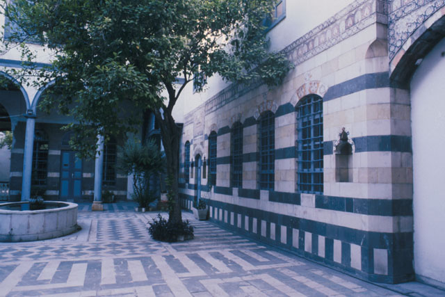 Exterior view showing ablaq design paving and wall patterning