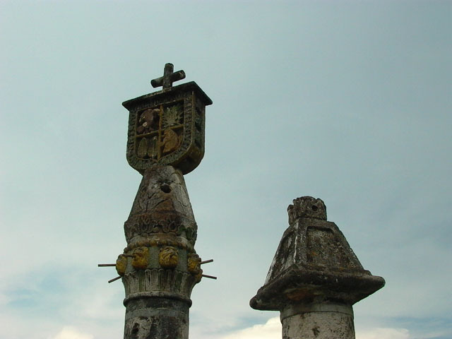 Detail exterior view of stone carved coat of arms atop a column