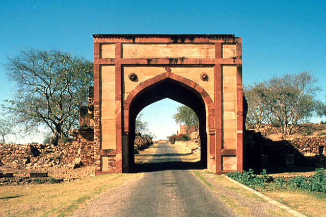 Exterior close-up view  of arched gateway toward southwest and road