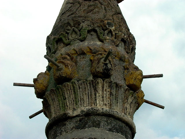 Detail exterior view of base below carved stone coat of arms