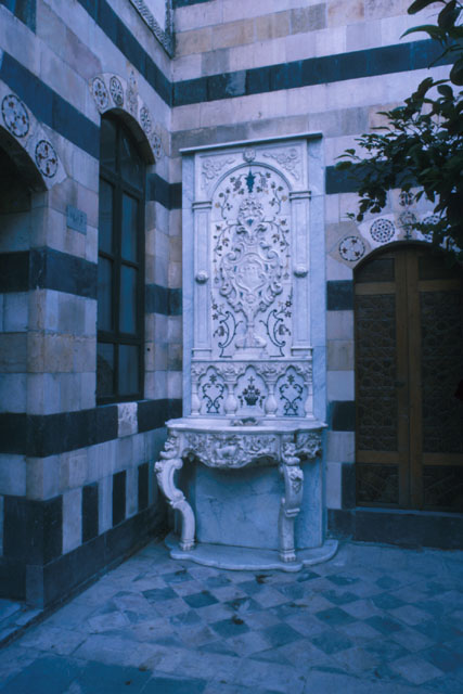 Exterior view showing carved baroque ablutions fountain