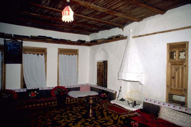 House interior with embedded shelves and fireplace