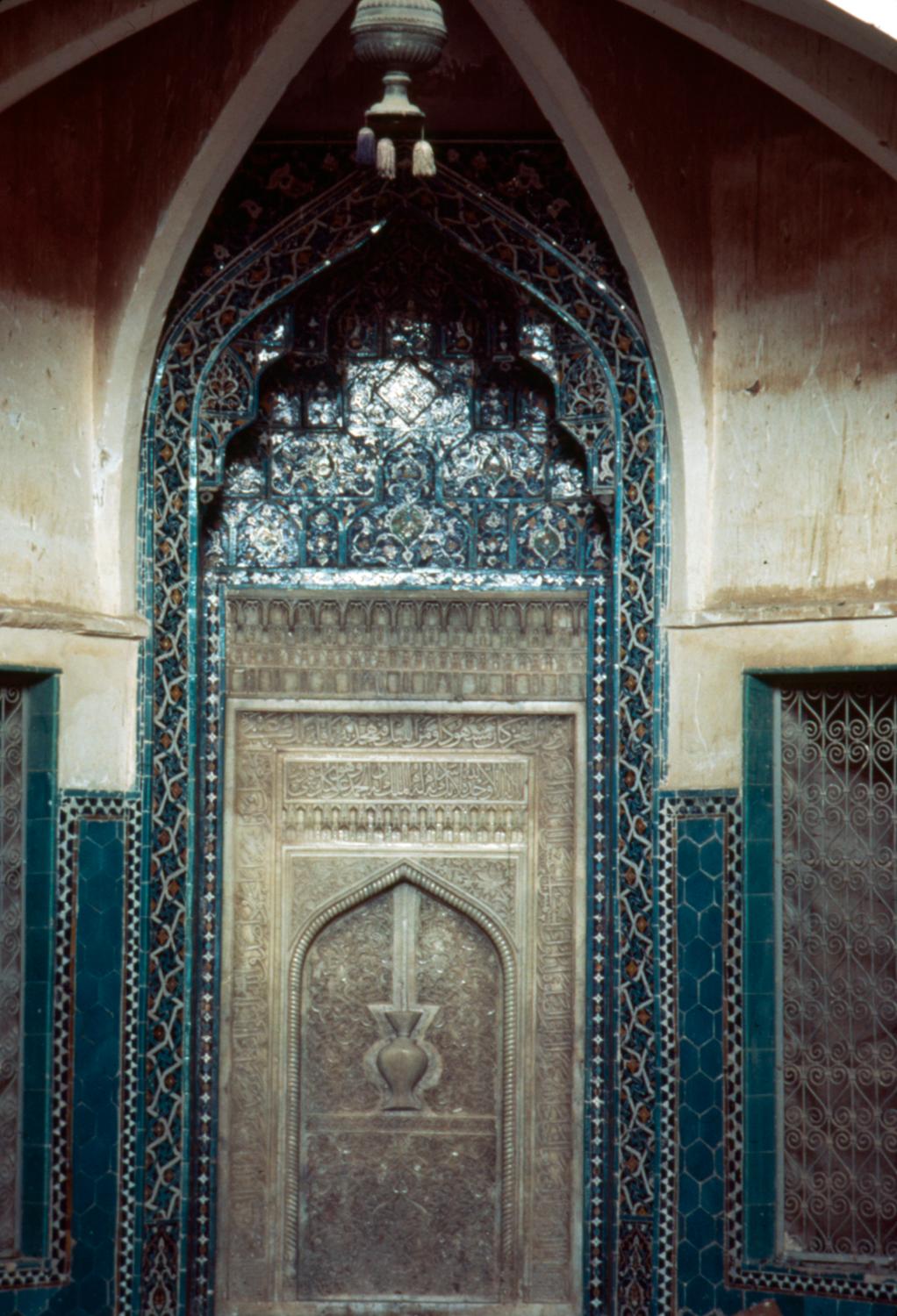 Decorative mosaic tile borders around the mihrab