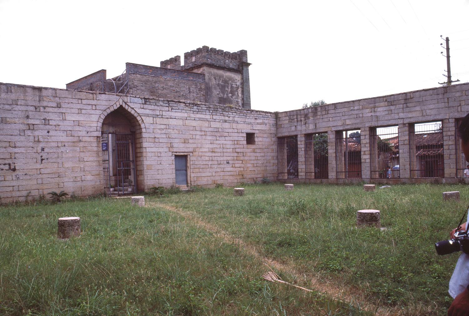 View of southeast corner of prayer hall, with the arched entrance seen on the left