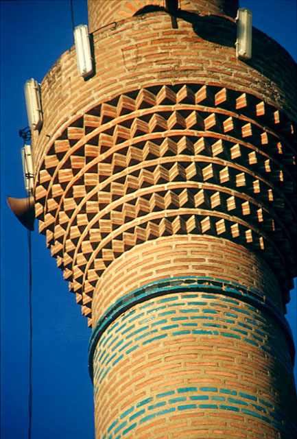 Exterior detail showing red and blue glazed bricks on the shaft of the minaret and saw-tooth brickwork of the balcony (serefe)
