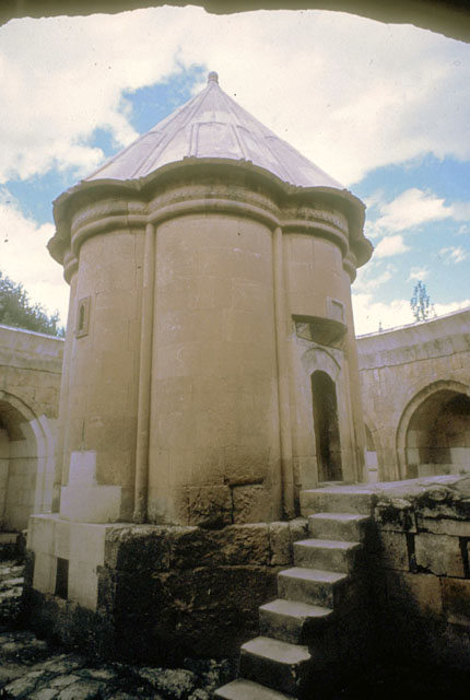 View of tomb tower in courtyard, looking northeast at doorway and staircase