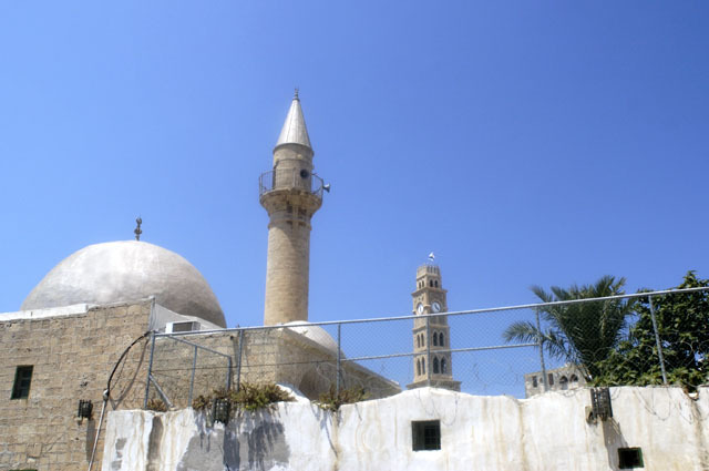 Bahr Mosque in Acre - East façade and courtyard wall. Tower of Khan Umdan rises in the background
