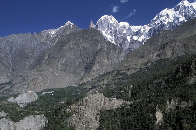 Distant view from south, showing the fort's tower on a clifftop (center) with the Karakoram mountains in the background