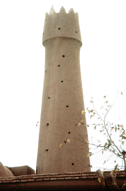 The tapering mud minaret with its projecting balcony