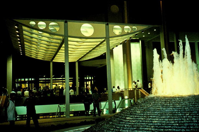 Night view of the steel entrance canopy with glass wall on the right