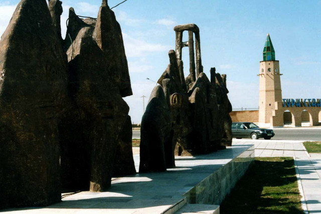 Modern sculpture, with symbolic gateway in the background