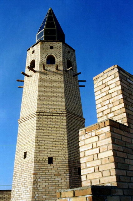 Minaret behind symbolic gateway