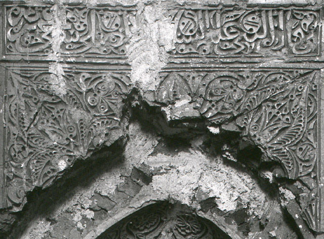 Detail of stucco mihrab, showing inscription above niche