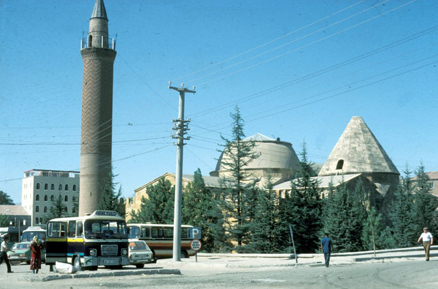 Exterior view from southeast showing the minaret, the madrasa dome and the conical dome of the Caca Bey Tomb