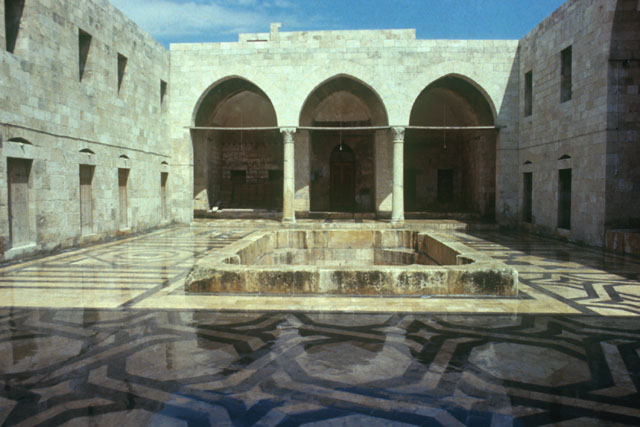 Exterior view showing open central courtyard with fountain encompassed by large interwoven geometric patterning