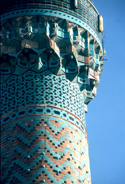 Exterior detail of the minaret showing ornamentation with glazed tiles on the shaft and the muqarnas support of the balcony (serefe)