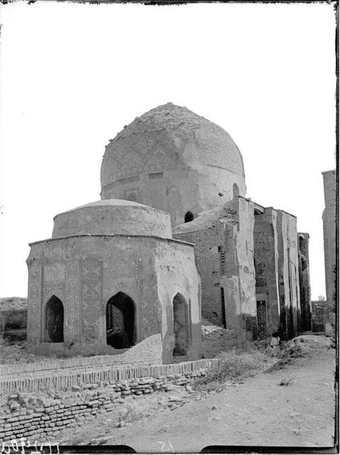Exterior view from the northwest, with the dominant Shirin Biqa Aqa mausoleum beyond