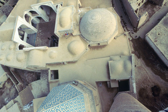 View looking down into mosque courtyard from minaret. The conical dome of the Shaykh's tomb appears next to the minaret shaft
